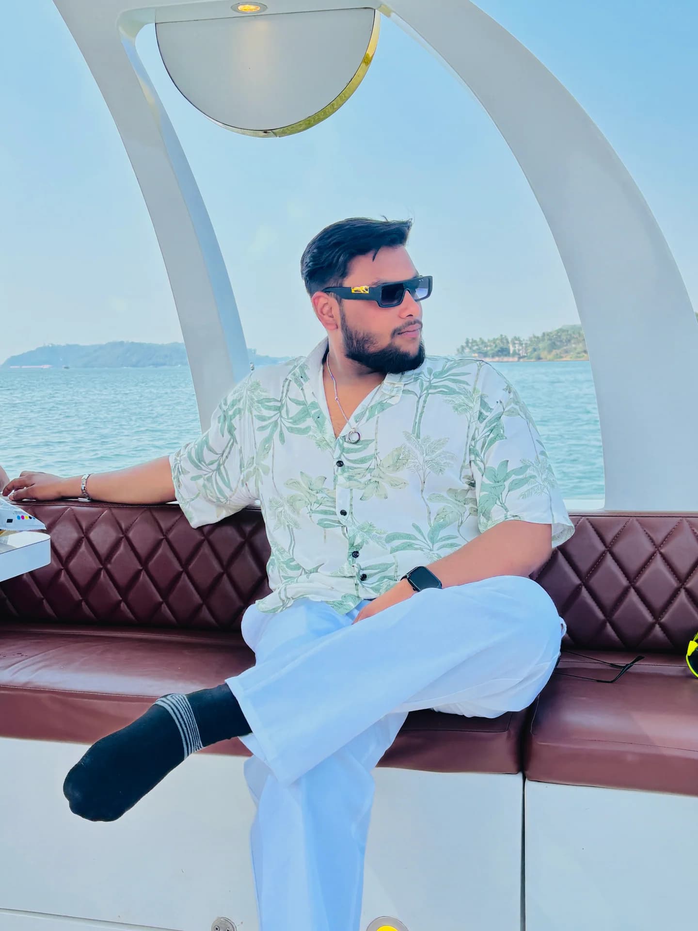Vansh Jain, Founder and CEO of ExploreYatri, seated on a boat