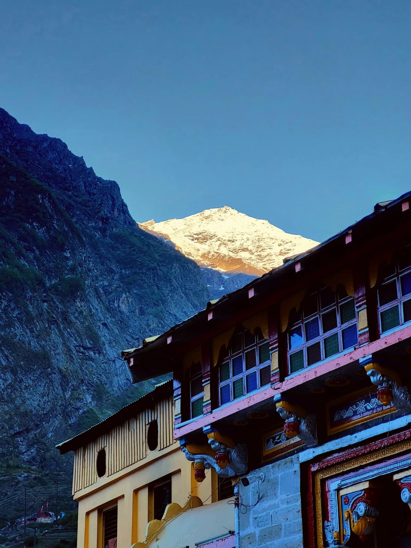 Badrinath temple area with snow-capped Himalayan mountains